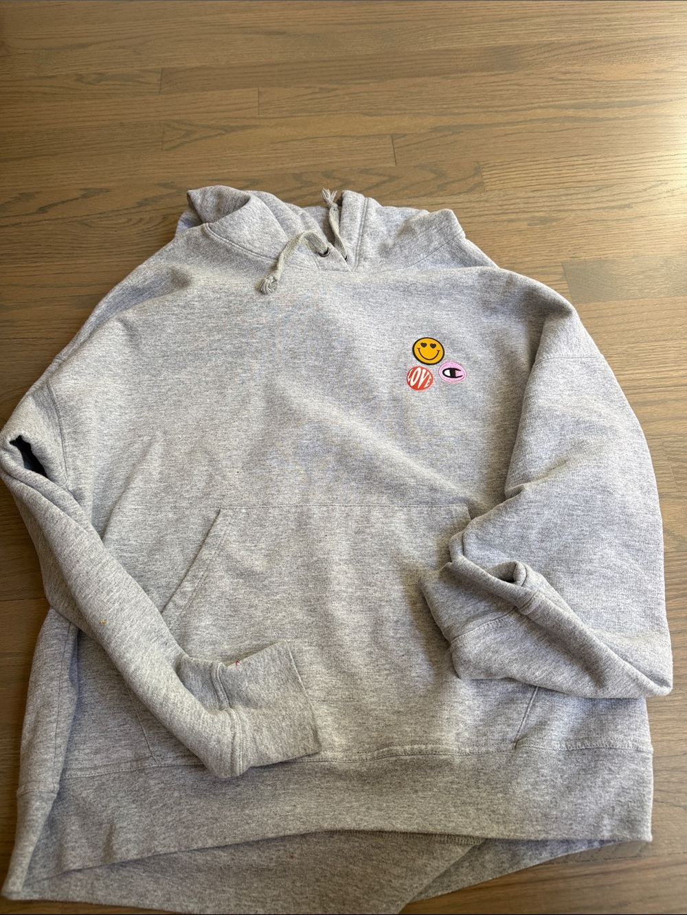 Champion Light Gray Hoodie with Smiley and Patch Accents